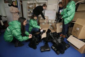 Volunteers sort the combat boots