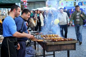 Cooks fry potatoes and barbecue