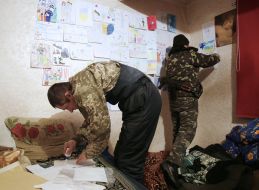 Ukrainian soldiers hang children's drawings