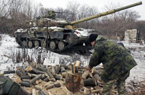 Ukrainian soldier chops wood