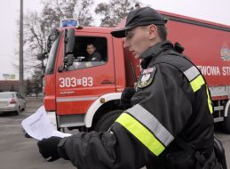 Polish firefighters near their cars