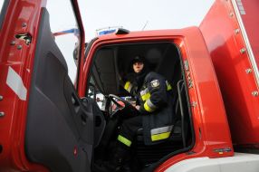 Polish firefighters near their cars