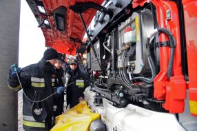 Polish firefighters near their cars