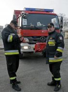 Polish firefighters near their cars