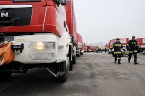 Polish firefighters near their cars