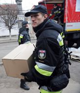 Polish firefighters near their cars