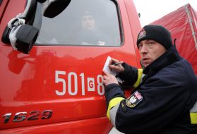 Polish firefighters near their cars