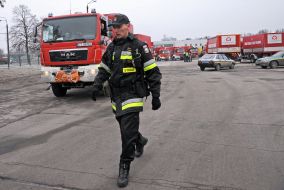 Polish firefighters near their cars