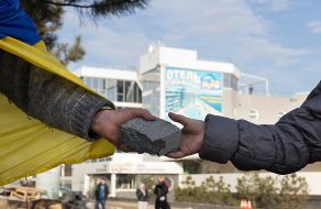 Activists pass disassembled pieces of roadway