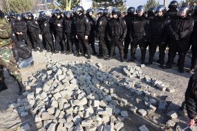 A pile of paving stones at police officers