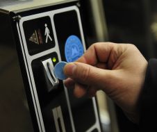 People pass through the turnstiles in the subway