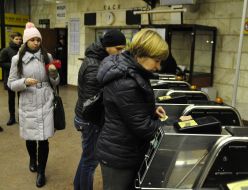People pass through the turnstiles in the subway