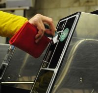 People pass through the turnstiles in the subway