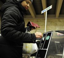 People pass through the turnstiles in the subway