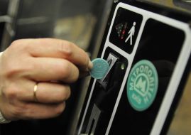 People pass through the turnstiles in the subway