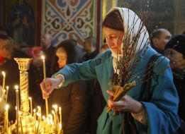 A woman lights a candle