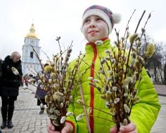 A girl carries consecrated willow