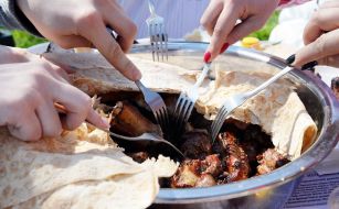 People eat kebabs