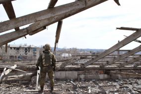 Soldier on the roof of the destroyed school