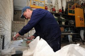 Convicted sews a sack of flour