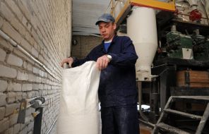 Convicted sews a sack of flour
