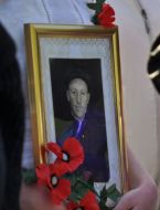 A woman holds a portrait
