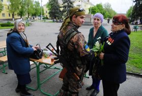 Ukrainian soldier talking to local women