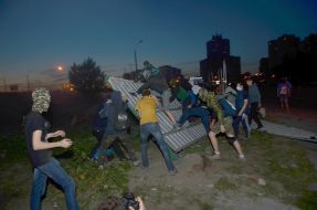 Люди ломают забор