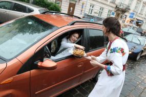 The girls in embroidered shirts handed out sweets to drivers