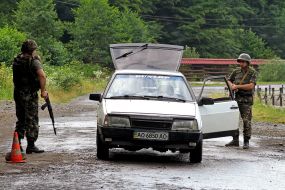 Soldiers check a car