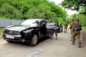 Soldiers check a car