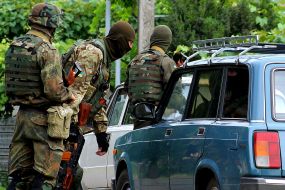 Soldiers check a car