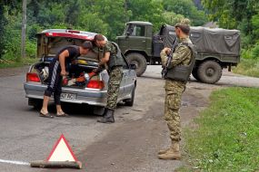 Soldiers check a car