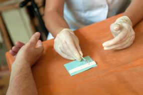 A nurse holds a test for hepatitis C