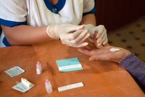 A nurse holds a test for hepatitis C