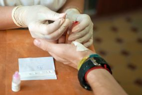 A nurse holds a test for hepatitis C