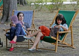 Women sit in the sun loungers