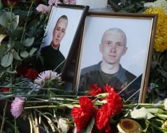Flowers near the portraits of dead soldiers