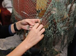 Women weave camouflage nets
