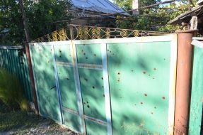 Bullet holes in the fence
