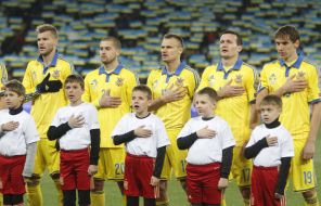 Players of national football team sing the national anthem