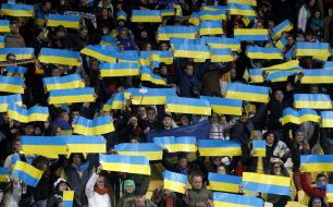 The supporters holding flags of Ukraine