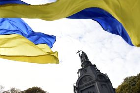 Ukrainian flag on the background of the monument to Volodymyr