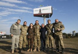 Gennady Korban photographed against the backdrop of billboards
