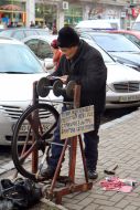 The man sharpens scissors