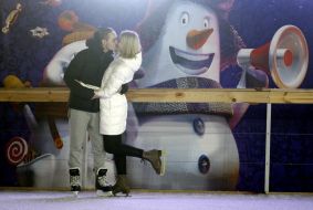 A couple kisses at the rink