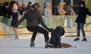 The girl fell to the ice rink