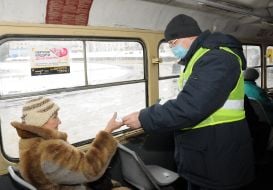 The man gives the woman a mask