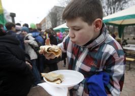 The boy eats a pancake