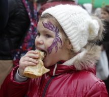 The girl eats a pancake